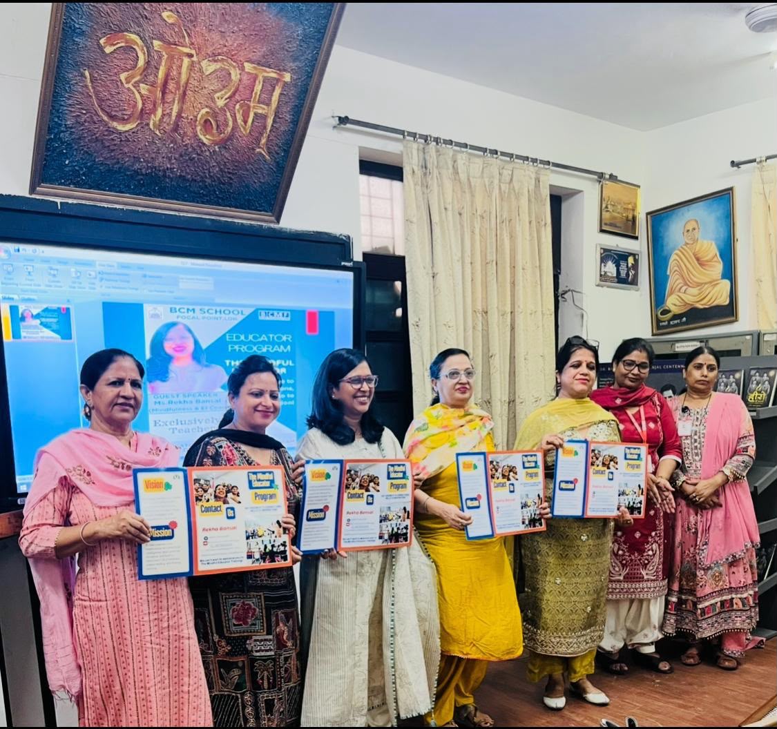 Teachers holding Mindful Educator Program brochures with Rekha at BCM School